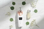 Veluné Aura Pore Clean Vacuum flat lay with serum and leaf on marble