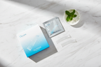 Veluné Aura Advanced Teeth Whitening Strips flat lay on white marble