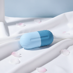 Veluné Aura Ice Sculpting Roller on white linen with petals