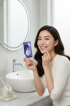 Woman applying Veluné Aura Advanced Teeth Whitening Strip