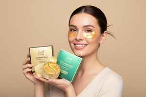 Woman smiling holding Veluné Aura Hydrating Eye Repair Patches packaging