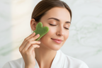 Woman using Veluné Aura Sculpting Gua Sha Stone in spa setting
