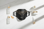 Veluné Aura LED Skin Renewal Mask flat lay with skincare accessories on marble surface