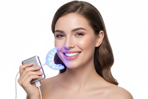 Woman smiling with bright white teeth holding Veluné Aura LED Teeth Whitening Kit