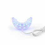 Close-up of Veluné Aura LED Teeth Whitening Kit mouthpiece glowing blue