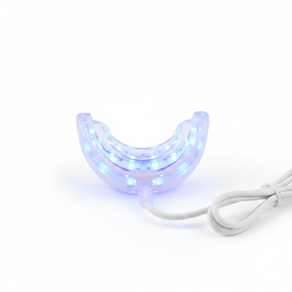 Close-up of Veluné Aura LED Teeth Whitening Kit mouthpiece glowing blue