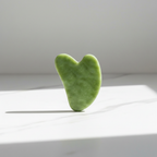 Veluné Aura Sculpting Gua Sha Stone on white marble surface