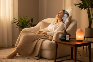 Woman relaxing with Veluné Aura Calm Mist Diffuser in cozy room