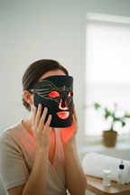 Woman holding Veluné Aura LED Skin Renewal Mask to face